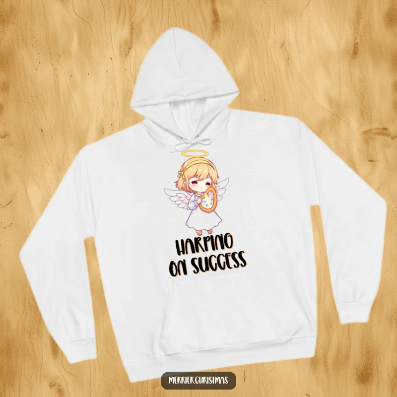 Funny Angel Hoodie showcasing a character dressed as an angel, playing a tiny, radiant harp, offering cozy and heavenly holiday cheer.