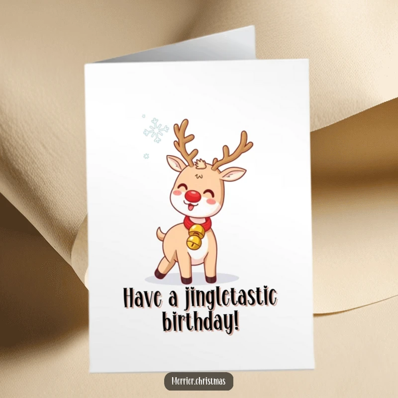 Funny Free Printable Birthday Card: Kawaii reindeer with a jingle bell collar gleefully tossing a snowflake.